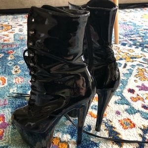 Black patent leather pleaser boots. Size 7, 7 inch heel.